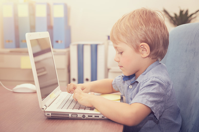 Little boy working on the laptop