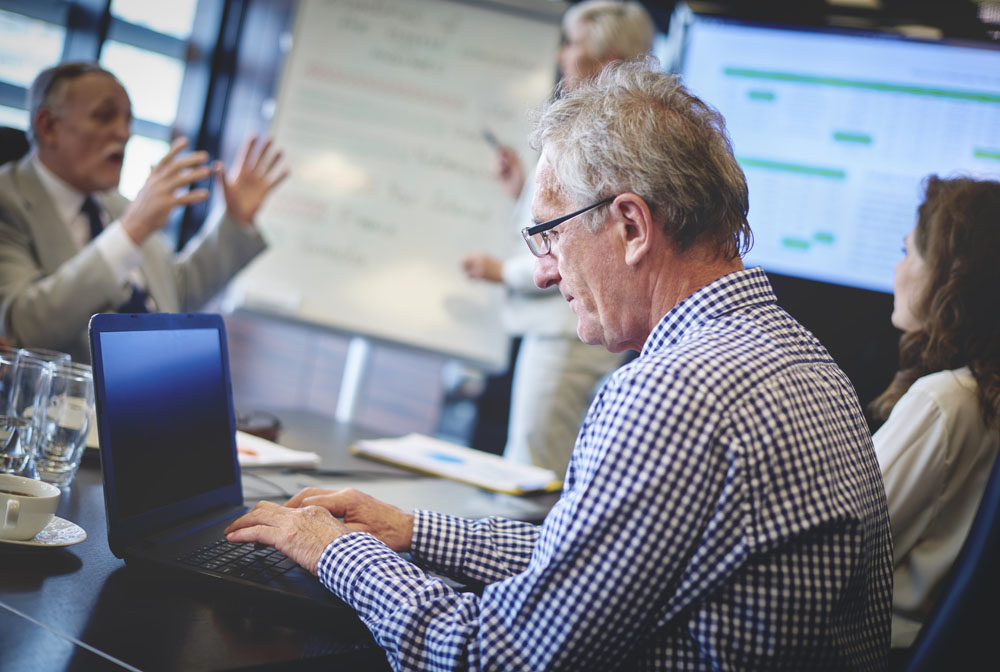 Senior adult business man using laptop