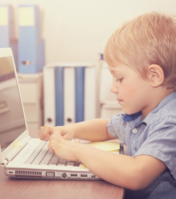 Little boy working on the laptop